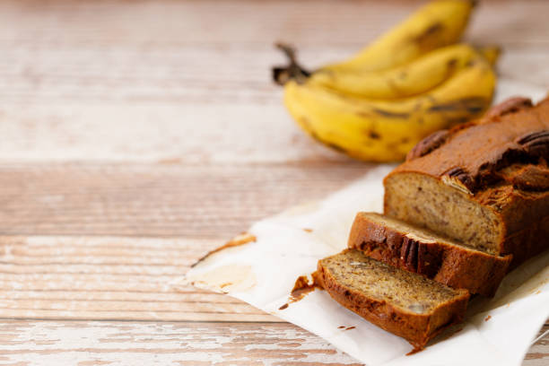 istock Banana bread loaf on wooden table. 2200747045