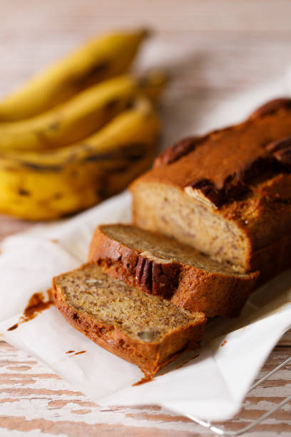 istock Banana bread loaf on wooden table. 2200747050