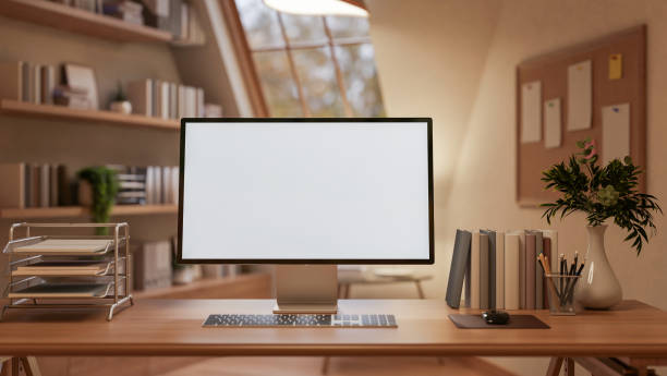 A White screen computer on the wooden table with decorative items, Workspace with glass window.