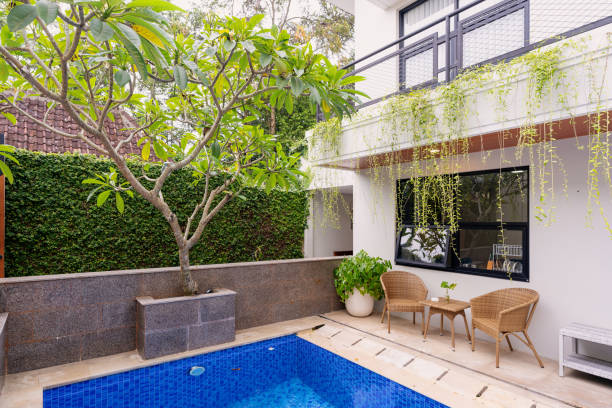 istock Tranquil Outdoor Poolside with Lush Greenery and Cozy Seating Area 2200755818