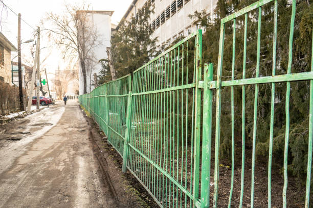 istock Green Metal Fence Along Urban Path 2200756327