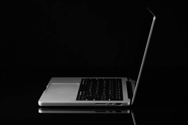 istock Laptop with a blank screen isolated on a black background 2200757873