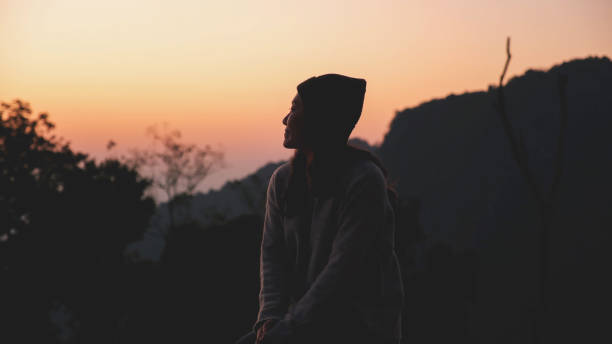 istock A woman looking at mountain views at dawn 2200759070