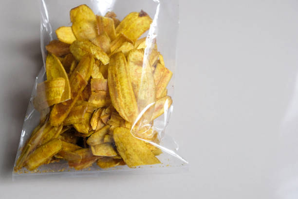 istock Close-up of banana chips in plastic packaging. 2200761258