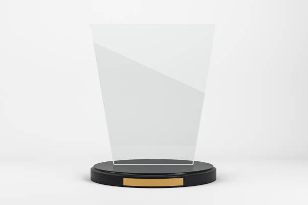 istock Blank glass award trophy mockup with black base and gold plaque on white background. Modern design for branding, winner display, or recognition. 3D Rendering 2200762155
