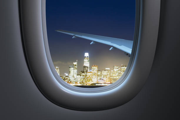 istock View from airplane window with city skyline at night. 3D Rendering 2200762318