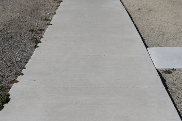 istock Looking Down at Sidewalk with Vegetation on one edge and Rocks on the Other 2200764451