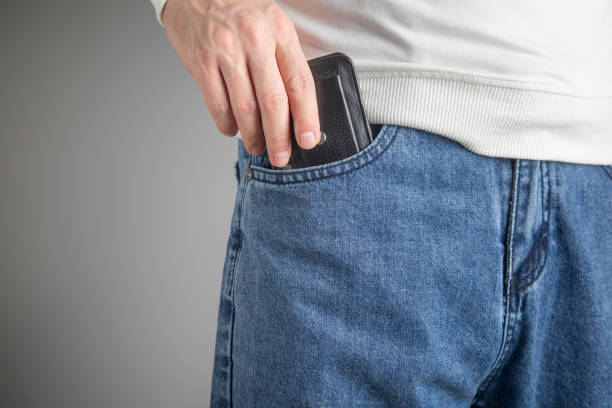 istock Man putting wallet in his jeans pocket. 2200765565