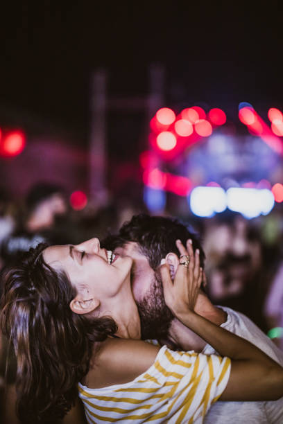 istock Affectionate couple on a music festival by night. 2200770118