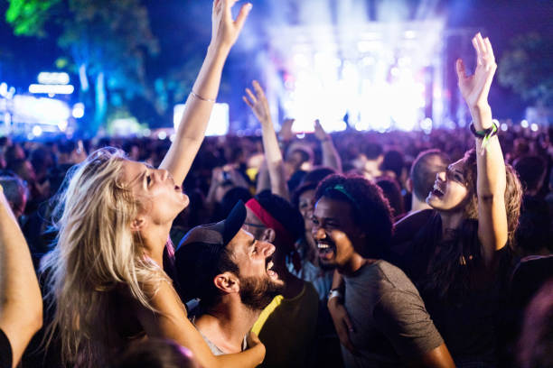 istock Carefree couples having fun while dancing on music festival. 2200770248