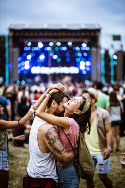istock Embraced couple having fun on music concert. 2200770418