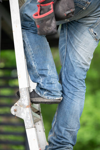 istock A worker climbs up a ladder while building a gazebo. 2200774730