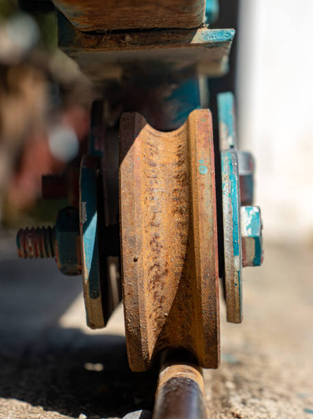 istock A rusty wheel from sliding gate on a rail, close up view 2200775906