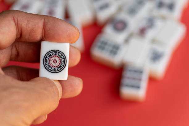 istock A person holding mahjong tiles 2200777433