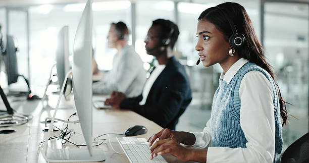 istock Call center, computer and typing with Indian woman in support office for customer service. Contact us, feedback and research with person speaking on headset in workplace for advice or virtual help 2200780532