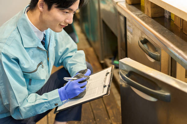 A man checking a restaurant's refrigerator stock photo
