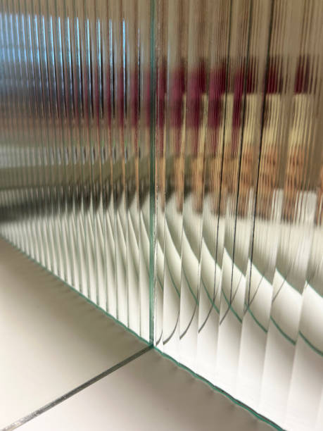 View through the corner of mirror and corrugated glass. Reflection in the mirror creates infinity effect and fluted glass creates distorted image.