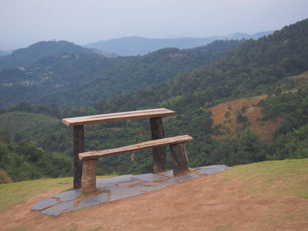 Wooden vintage bench and table on the mountain over green rainforest background.
