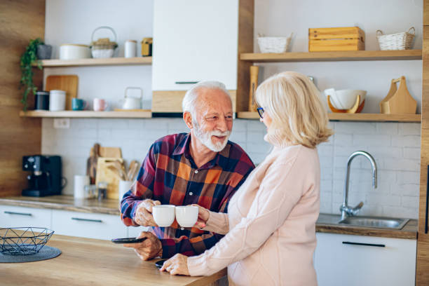 istock Senior couple enjoying morning coffee in the kitchen 2200785241