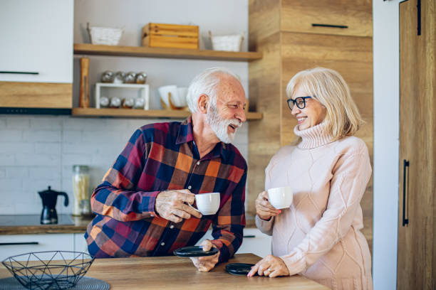 istock Senior couple enjoying morning coffee in the kitchen 2200785397