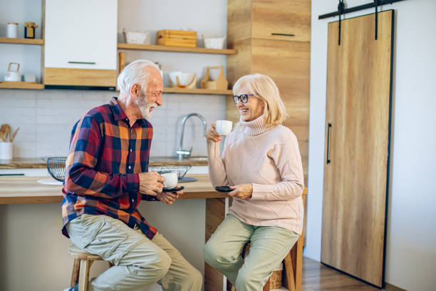 istock Senior couple enjoying morning coffee in the kitchen 2200785433