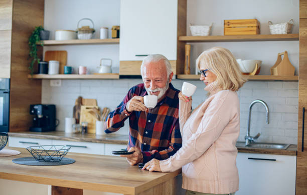 istock Senior couple enjoying morning coffee in the kitchen 2200785452