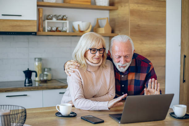 istock Senior couple having a video call while drinking coffee in the kitchen 2200785605