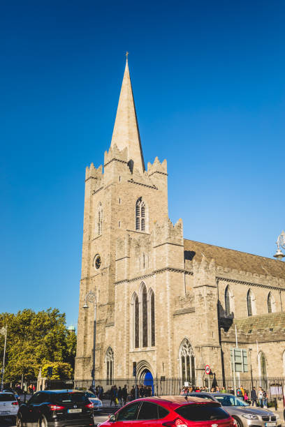 Dublin, Ireland - September 21, 2018: Exterior view of St. Patrick's Cathedral, a historic Gothic-style church with a tall spire, under a clear blue sky.