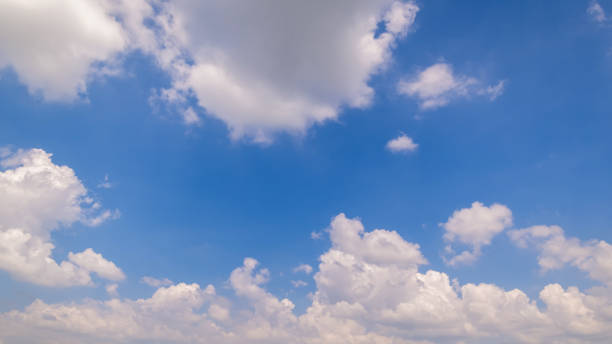 istock Panoramic view of clear blue sky and clouds, Blue sky background with tiny clouds. White fluffy clouds in the blue sky. Captivating stock photo featuring the mesmerizing beauty of the sky and clouds. 2200786738