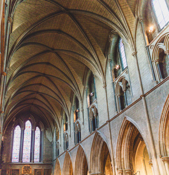 Dublin, Ireland - September 21, 2018: Interior view of St. Patrick's Cathedral showcasing its gothic vaulted ceiling, arches, and stained glass windows.