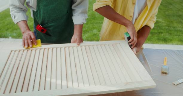 istock Grandfather teaches grandson to work with wood 2200788638