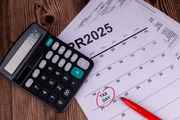 istock A desk setup with a calendar marked April 15th, calculators, and pencils, emphasizing the importance of timely tax form submission 2200790353
