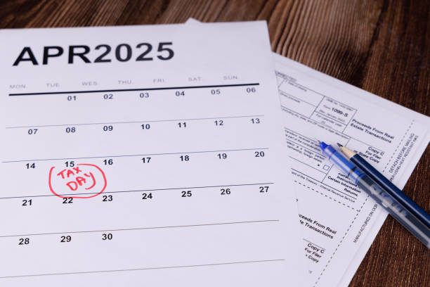 istock A workspace featuring a calendar circled in red for April 15th, calculators, and pencils, emphasizing tax preparation steps 2200790931