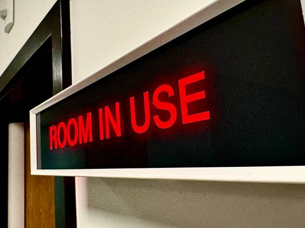 istock A neon information sign stating ROOM IN USE 2200792229