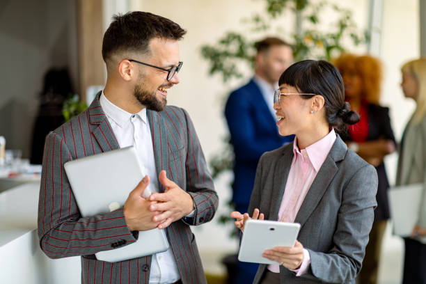 istock Business people talking and using digital tablet and laptop in modern office 2200792383
