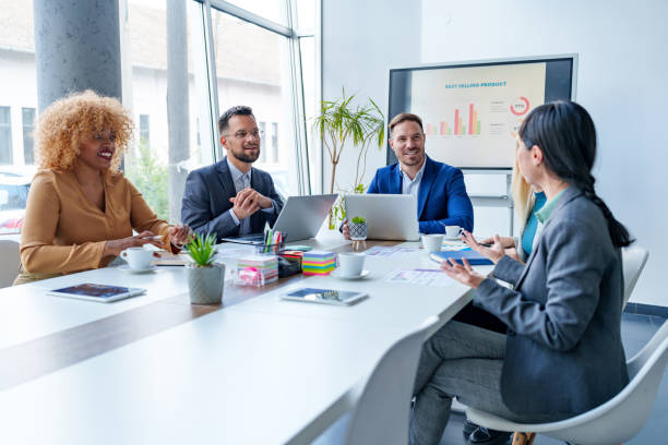 istock Business team discussing sales data during a meeting in a modern office 2200792403