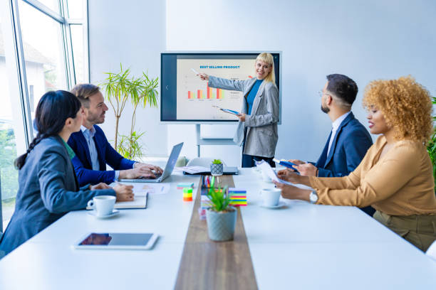 istock Businesswoman using interactive whiteboard during a presentation in the office 2200792475