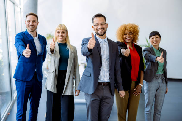istock Multicultural business team showing thumbs up in the office 2200792652