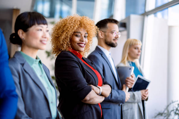 istock Diverse business team standing together in modern office 2200792699