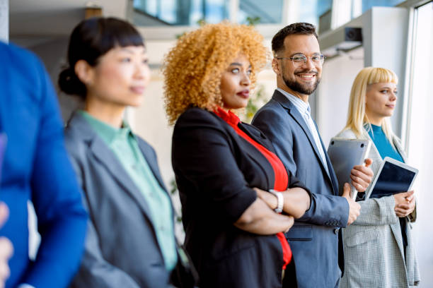 istock Diverse business team standing together in modern office 2200792703