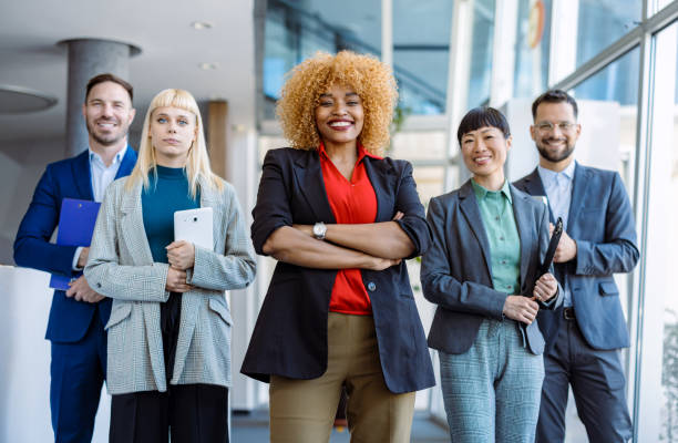 istock Confident business team smiling at camera in modern office 2200792714
