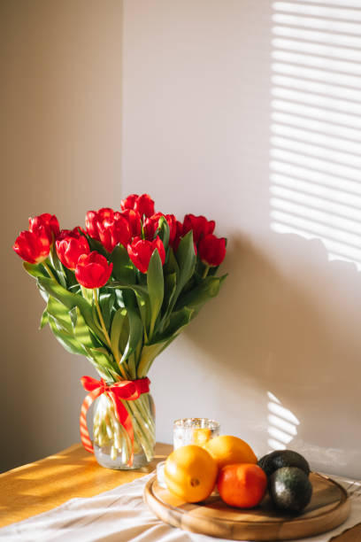 istock Beautiful Red Tulips on Kitchen Table in Morning Light 2200794406