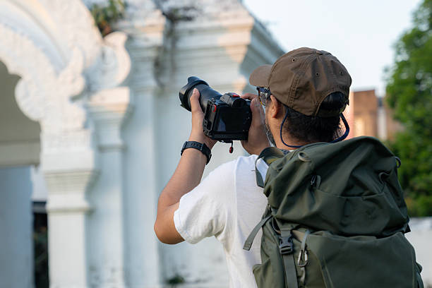 istock Young male tourist taking photos with camera 2200794417