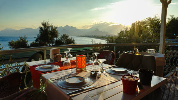 A luxurious restaurant with sea views is ready for dinner