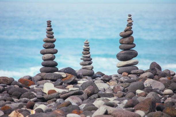 istock Stacks of balanced stones on the beach 2200794659