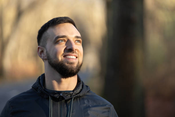 istock A young man looking at the nature around him and smiling 2200795136