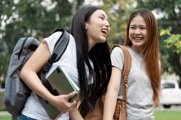 istock Diverse university students joyfully walking together on campus with backpacks. 2200798858