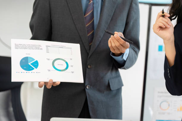 istock Businessman holding financial report with graphs during a presentation. 2200799662