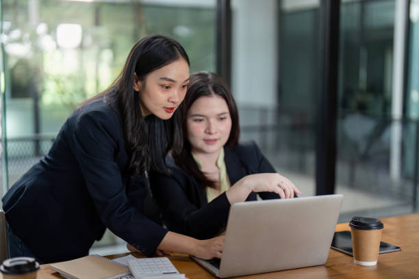 istock Diverse businesswomen collaborating on project analysis and planning in a modern office setting. 2200800298