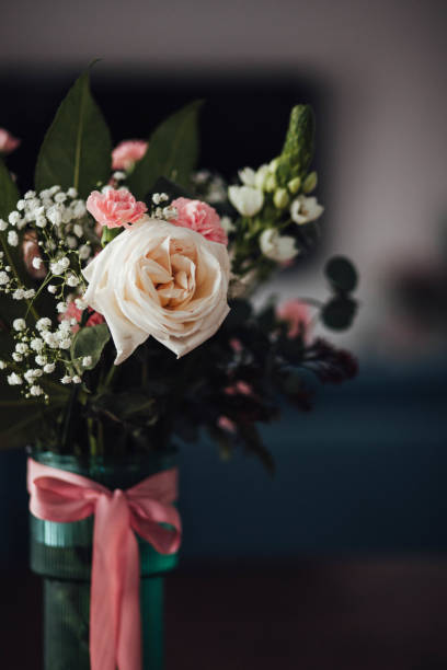 istock Bouquet of roses and carnations in a vase 2200802438